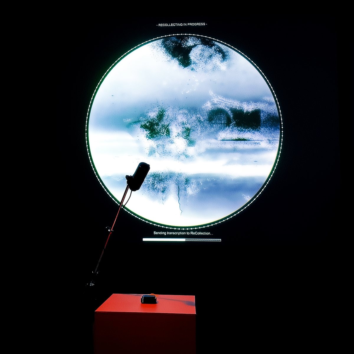 A generated memory on the round screen, the microphone in front of it